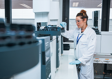A Eurofins BioPharma Product Testing scientist operating a gas chromatography system for ethylene oxide residual testing in a GMP-compliant laboratory environment.