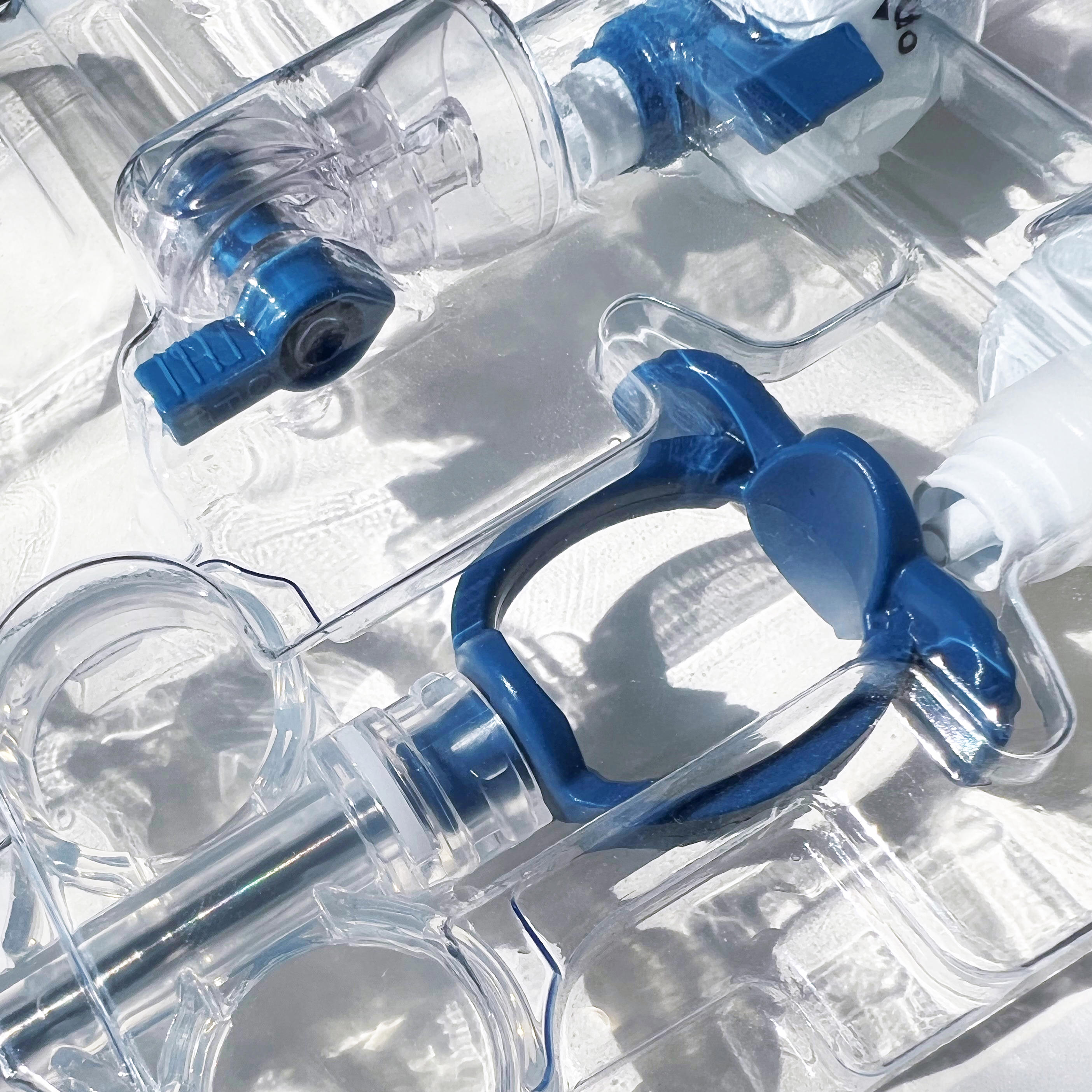 Close-up view of medical devices used in neurovascular procedures, featuring blue and transparent components with intricate designs for precision. The image is labelled 'Neurovascular'.