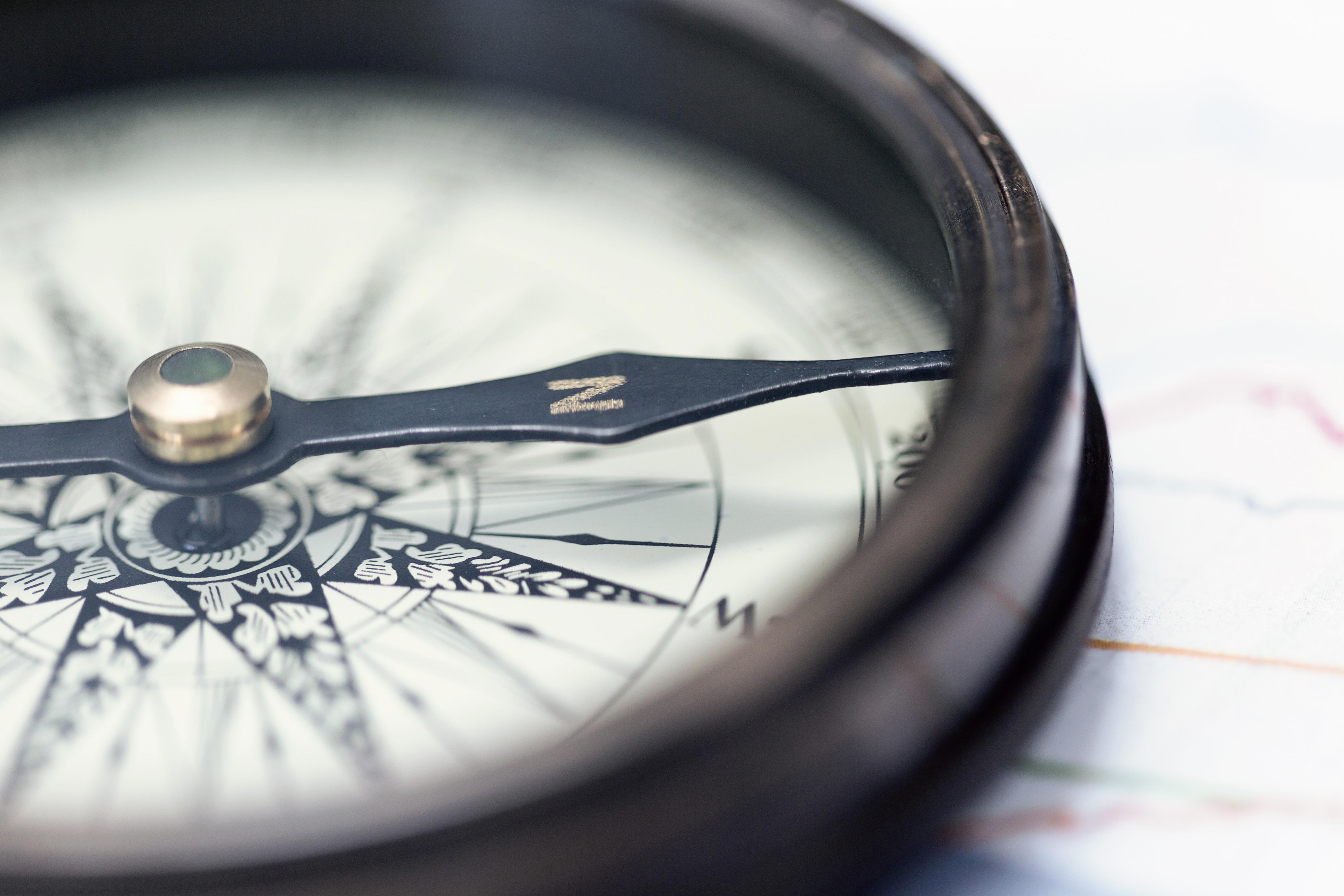 a-compass-on-charts-a-direction-of-success-cold-toning_-6000-x-4000-px (1)