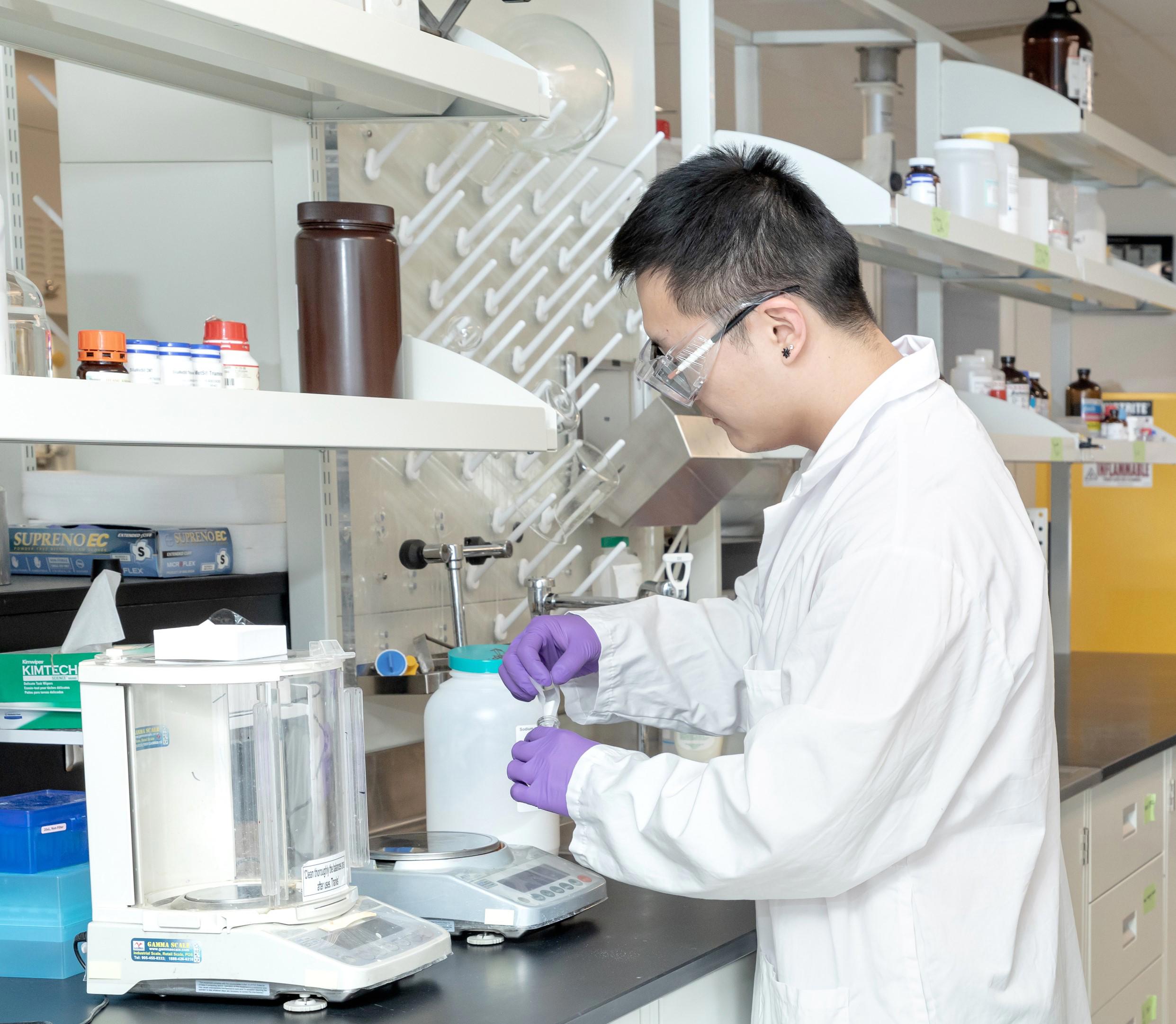 A scientist in a lab carrying out an assay