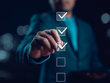 A person in a suit is checking off items on a virtual checklist