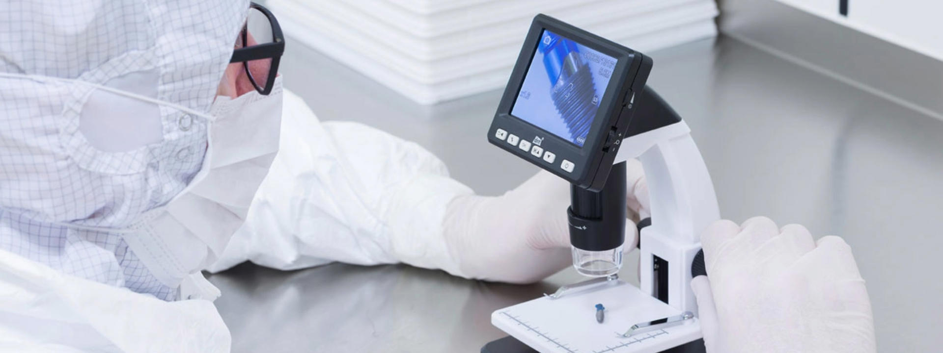 Lab technician performing a validation test on a medical device using specialized equipment.