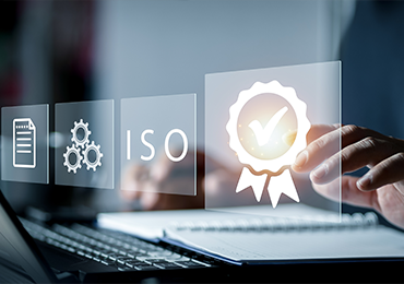 Person typing on a laptop with floating icons representing documentation, process control, ISO standards, and certification, illustrating MDS Consulting’s commitment to building compliant quality management systems