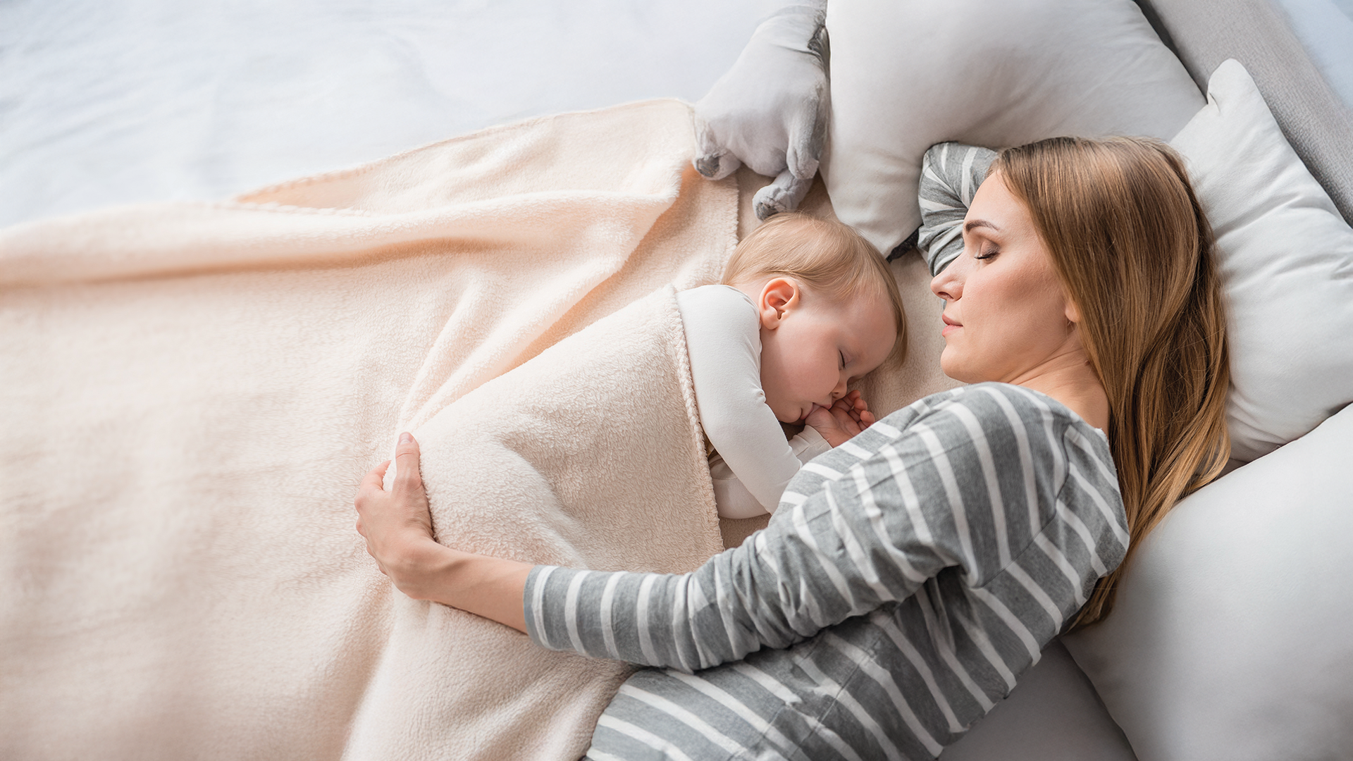 Reproductive medicine by Eurofins Clinical Diagnostics cover image of mother holding baby in a bed