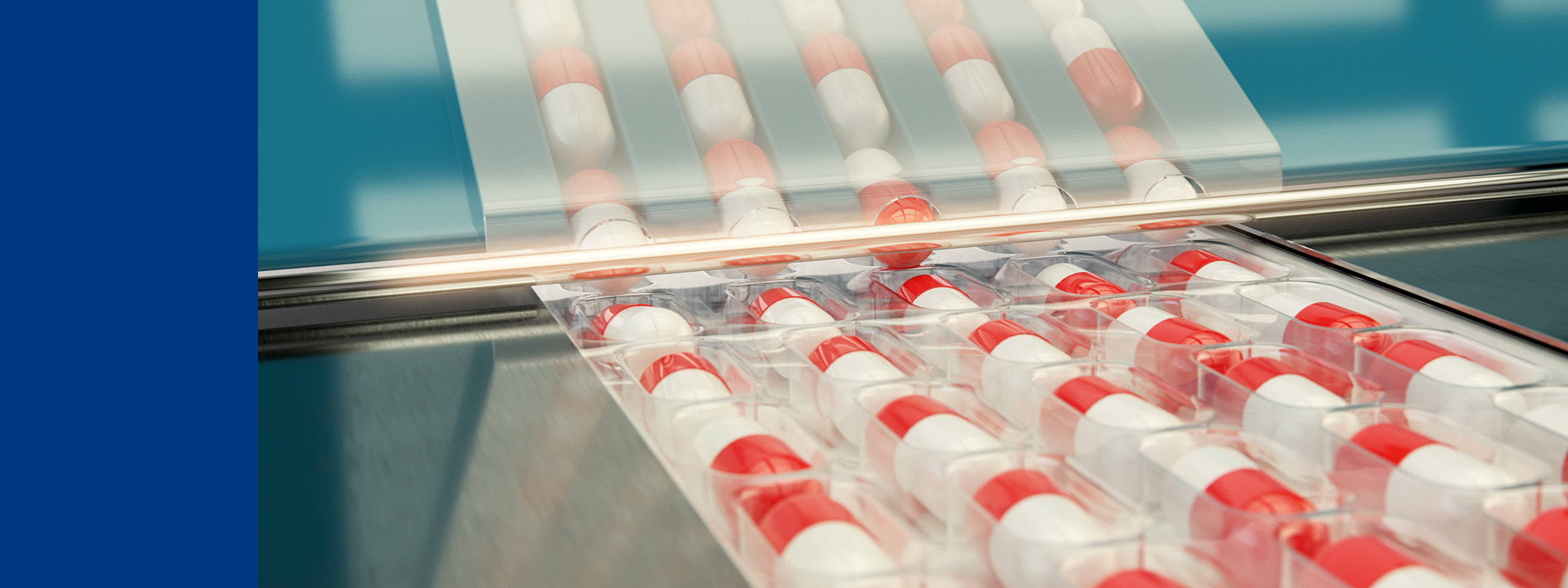 A packaging process for clinical trial supplies, specifically capsules. The capsules are red and white and are being packaged in transparent blister packs. The blister packs are arranged in rows and columns, moving along a conveyor belt under a sealing mechanism. This work is part of the clinical trial supplies management at Eurofins BioPharma Product Testing.